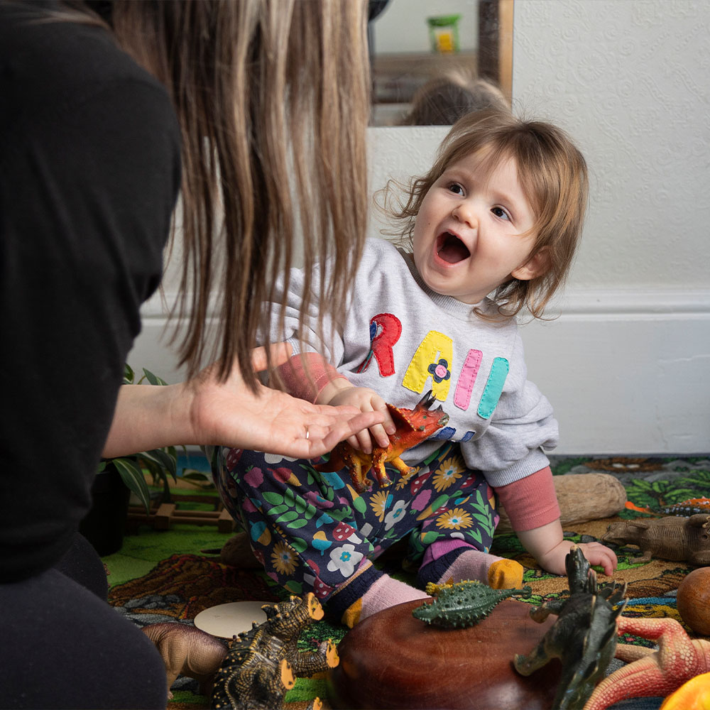 A smiling child playing at the nursery 